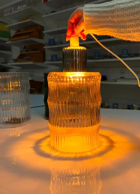 A small and a large vase lit together