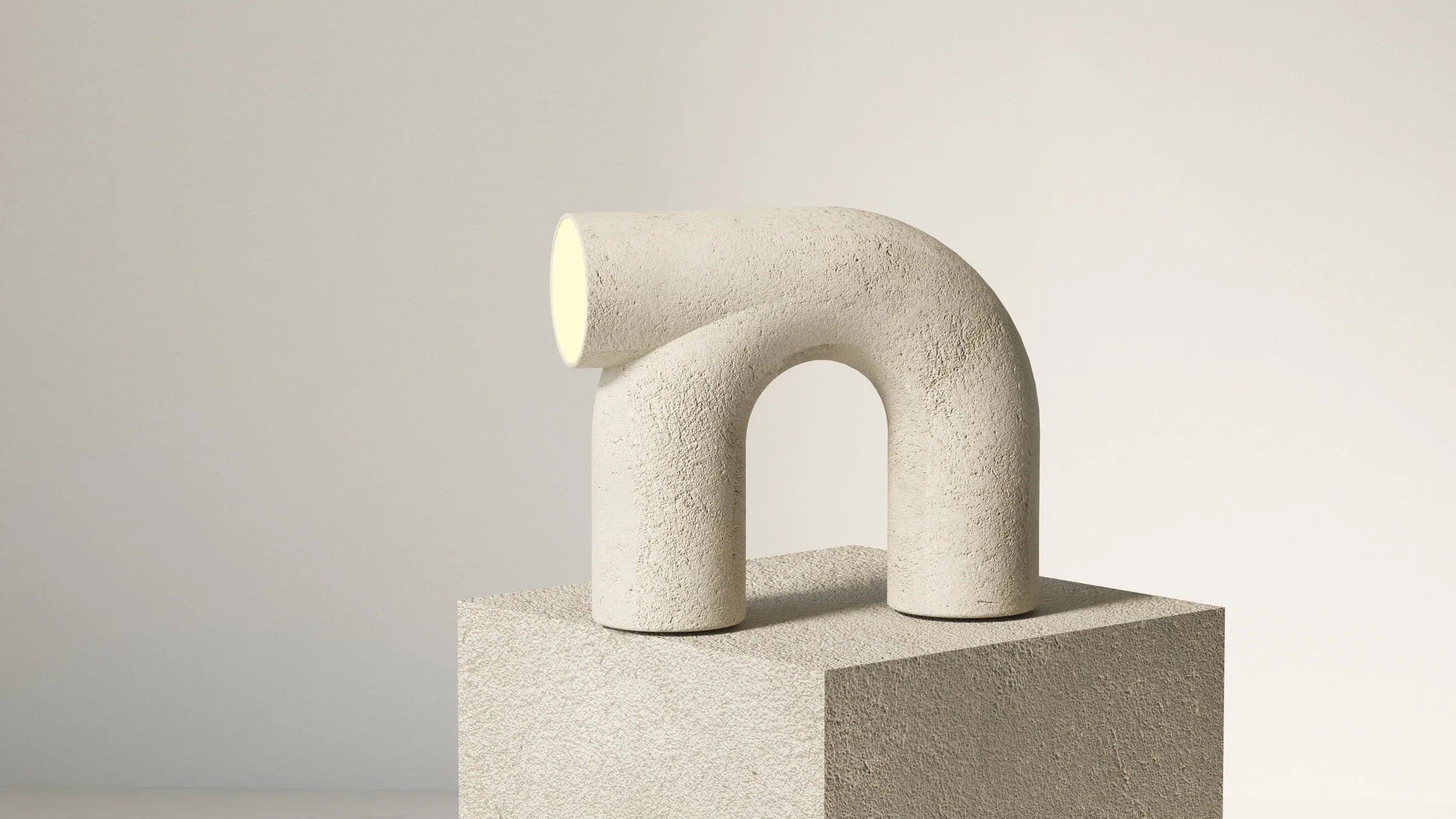 The arch lamp in rough concrete on a concrete plinth