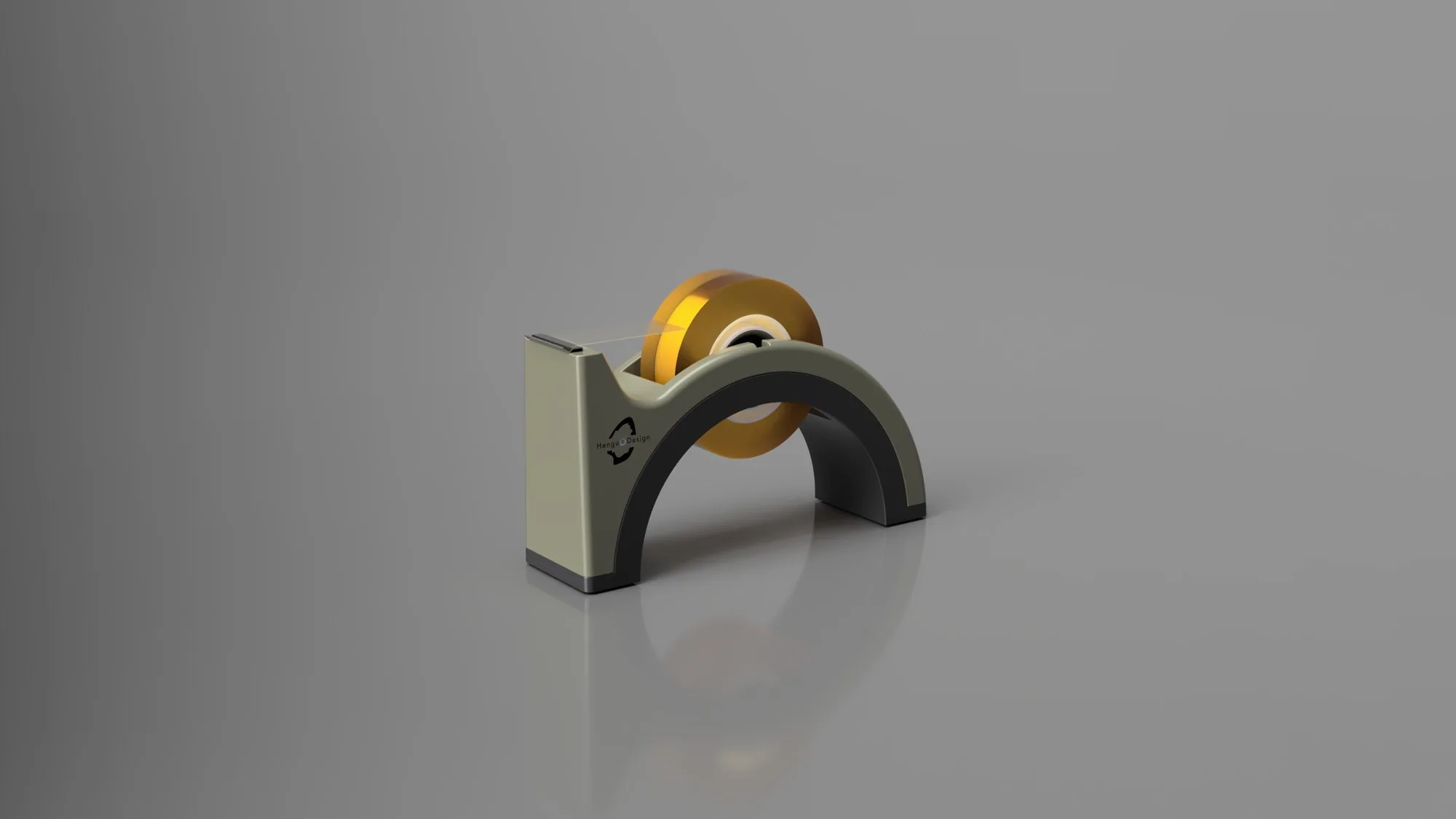 The tape dispenser in olive grey and black with an amber tape roll, on a grey studio floor