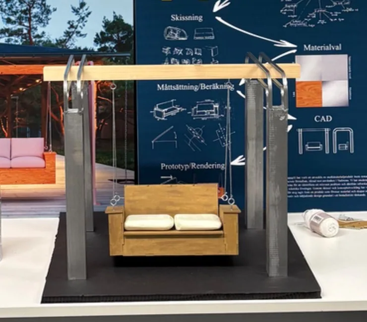 Close-up of the scale model: 3D printed legs, a wooden beam and a small sofa in spray-painted MDF with white cushions, hanging in wires